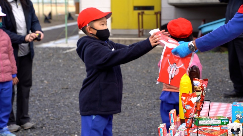 グリコ商品を受けとる子どもの画像